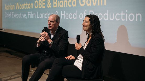 Adrian and Bianca sat on stage speaking