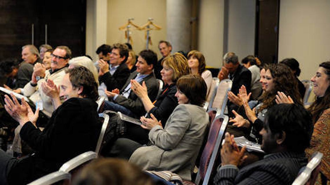 Audience members sat down and clapping