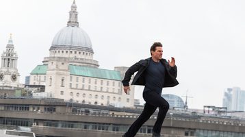 Still from Mission:Impossible - Fallout. Tom Cruise running across a London rooftop with St Paul's Cathedral in the background