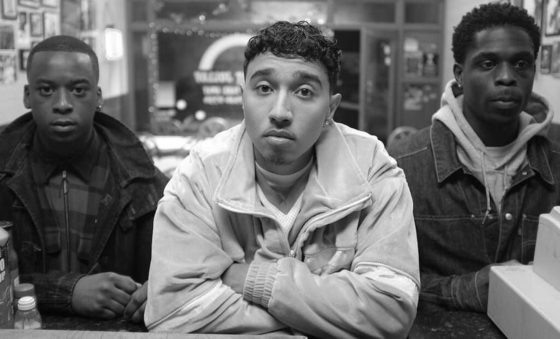 Still from Pirates. Three young men look directly at the camera.