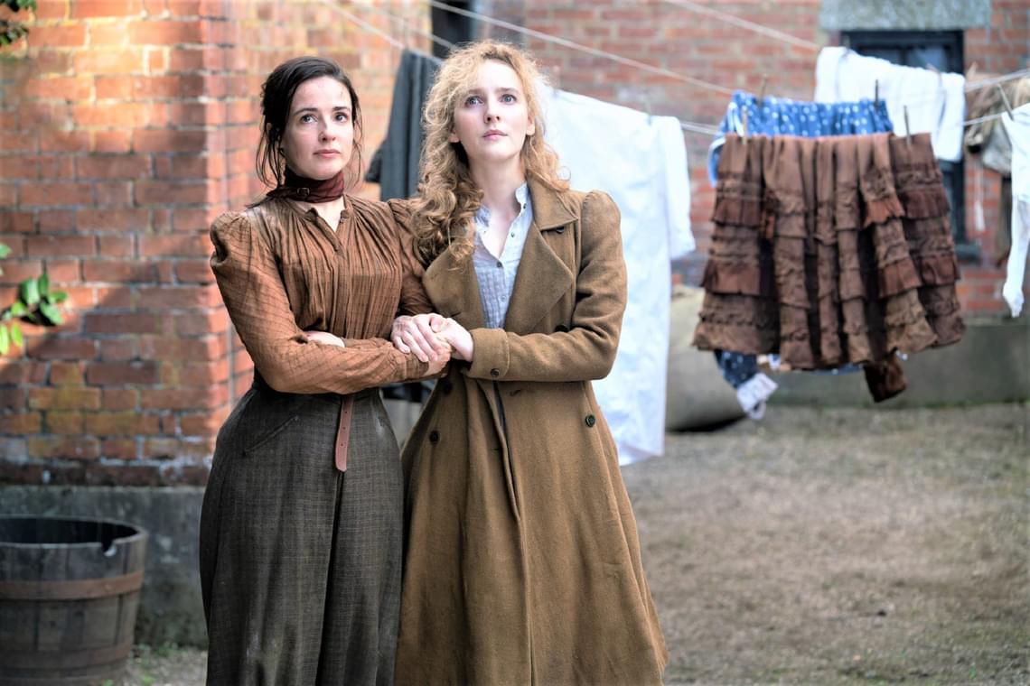 Still of The Nevers, two women in Victorian dress holding each other