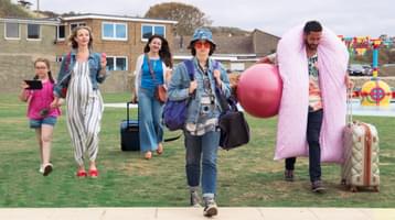 Still of Sweetheart. Five people walking toward the camera with various holiday attire.