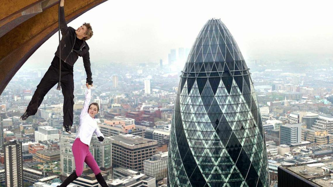 Still from the movie Stormbreaker in which two characters hang off a building with The Shard behind them.