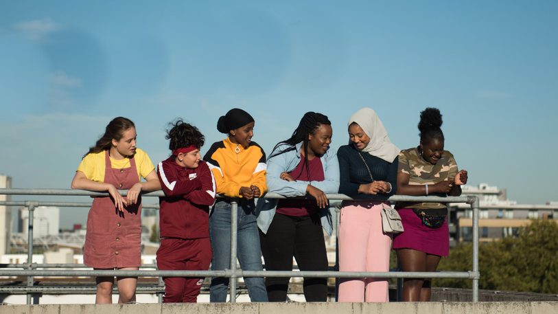 Still from Rocks featuring six young women looking over a railing.