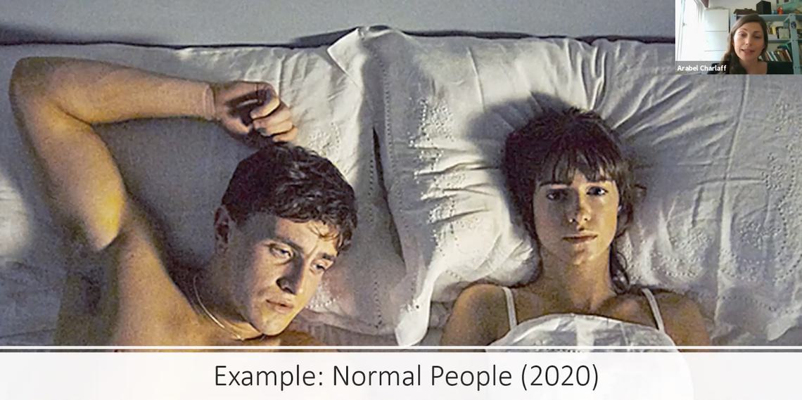 Still from Normal People in which two people lie next to one another in bed looking despondent.