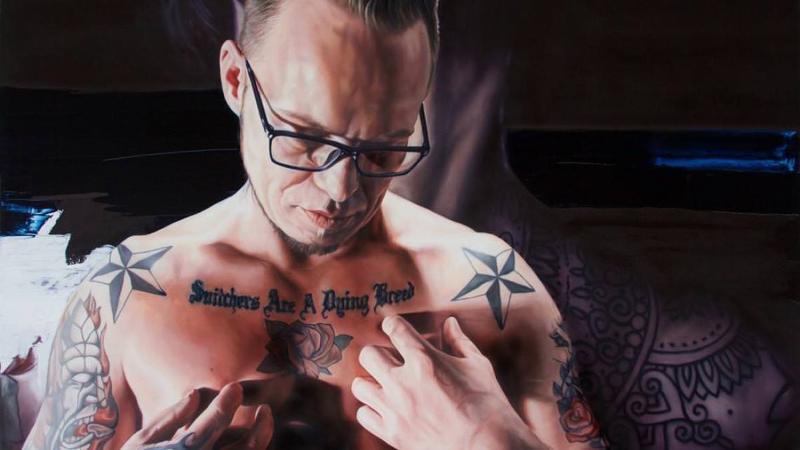 Still from Benjamin Ree's film The Painter and the Thief, featuring a picture of a man with chest tattoos
